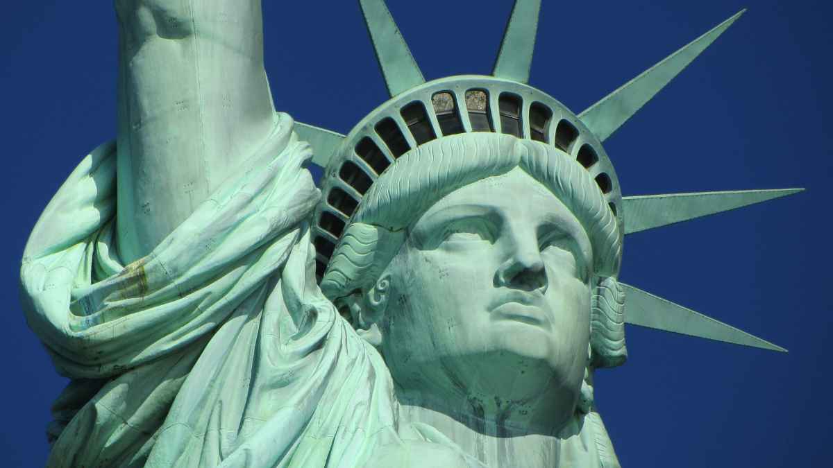 Close-up of the Statue of Liberty against a blue sky, representing new laws in New York for 2025.