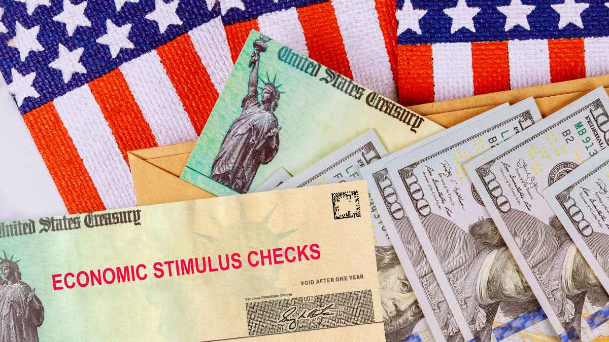 U.S. Treasury stimulus check, envelope and hundred-dollar bills on an American flag, illustrating the proposed $2,000 fourth relief payment