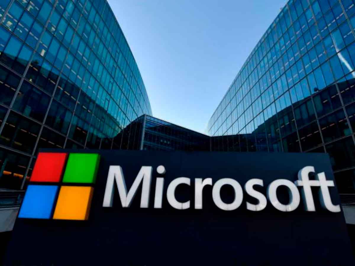 Microsoft logo outside glass office buildings, illustrating urgent call for Windows 10 users to upgrade to Windows 11