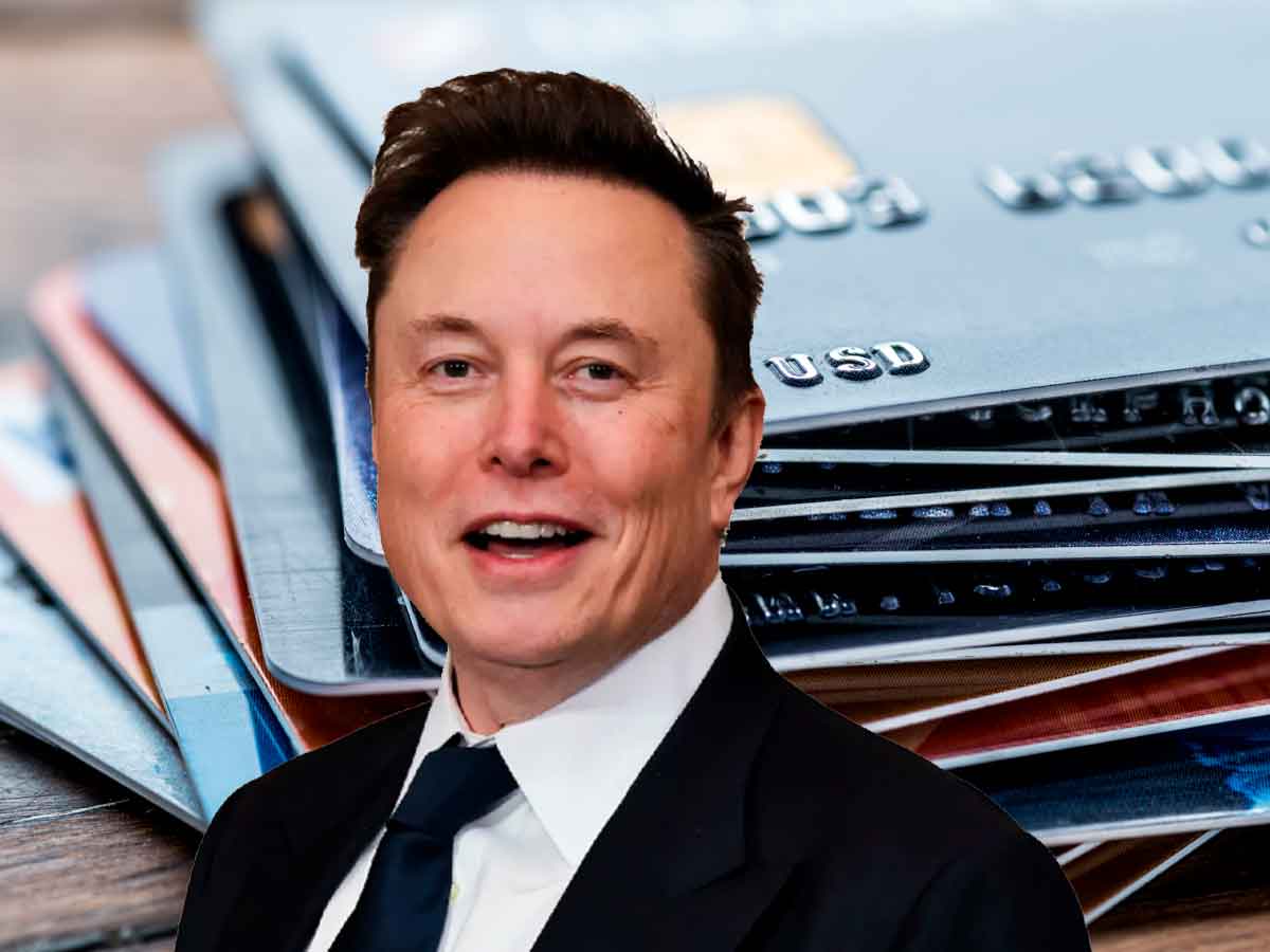 Elon Musk smiling in front of a blurred stack of credit cards, illustrating DOGE’s move to deactivate 470,000 federal accounts