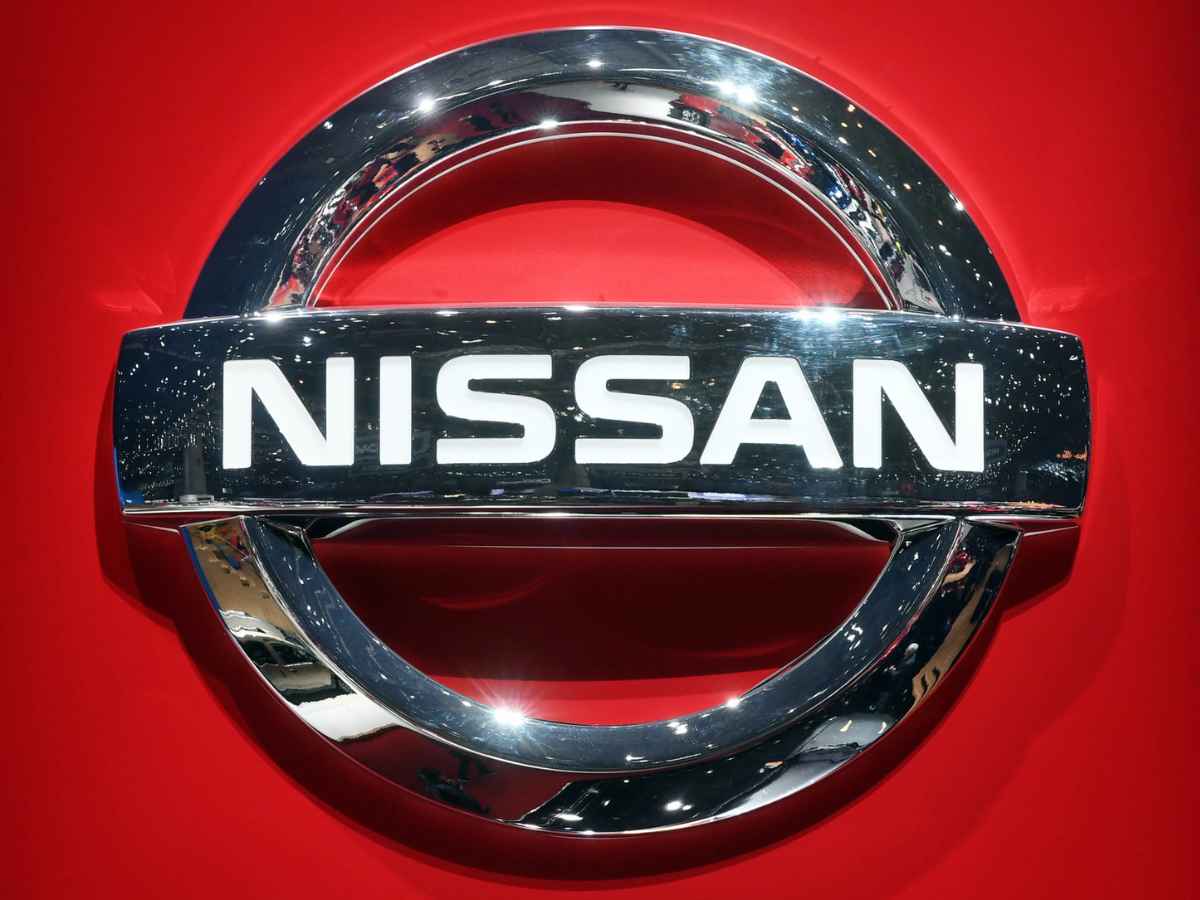 Nissan logo on red background amid door lock failure recall in the U.S.