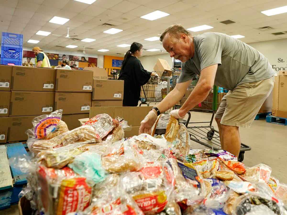Volunteer sorts donated bread at Los Angeles community food bank amid surge in demand fueled by rising grocery prices
