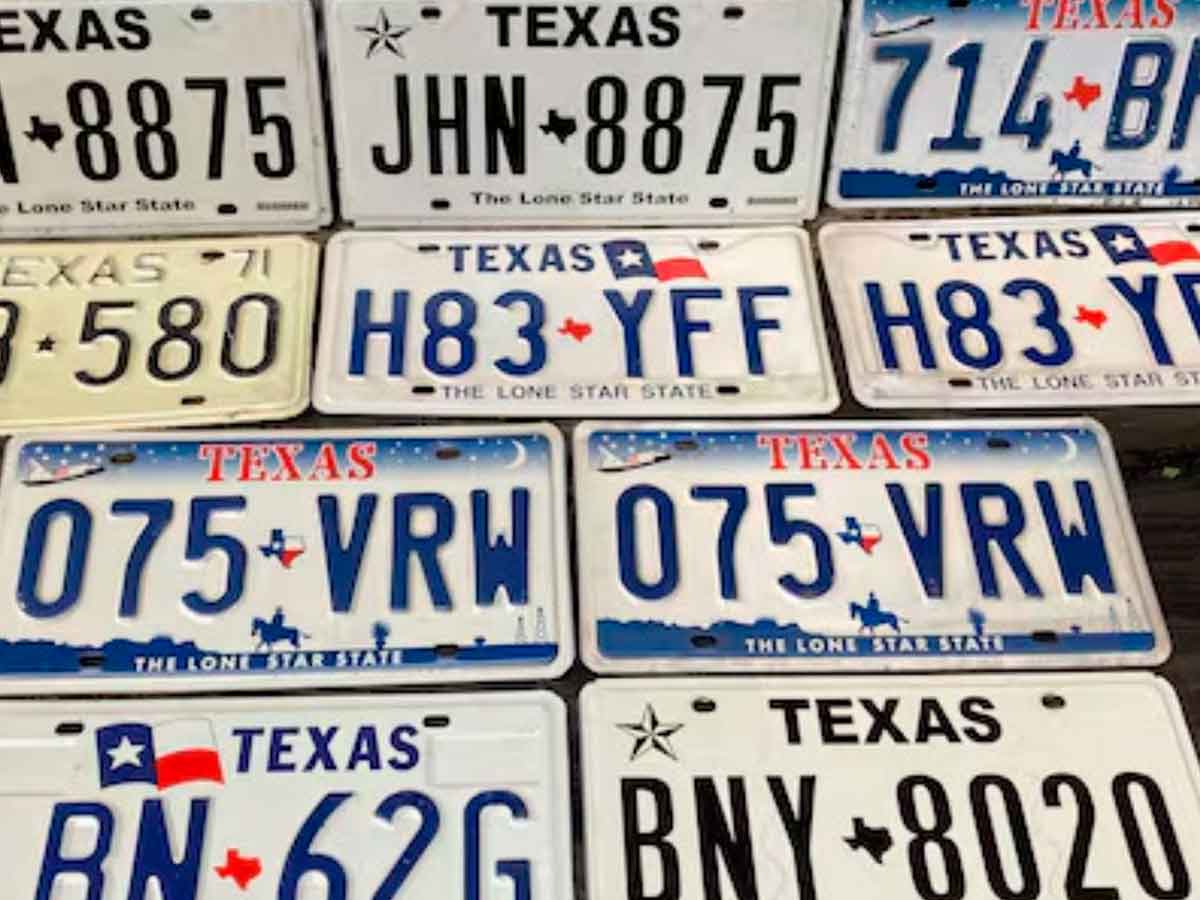 Assorted Texas metal license plates displayed side by side, reflecting the 2025 mandate replacing temporary paper tags with permanent plates
