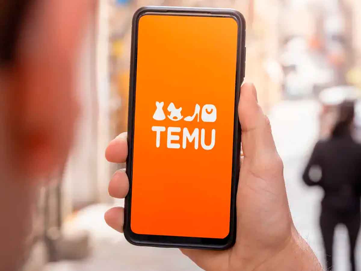 Smartphone displaying Temu app logo held in hand, illustrating looming price increases after Trump’s new import tariffs on low-cost goods