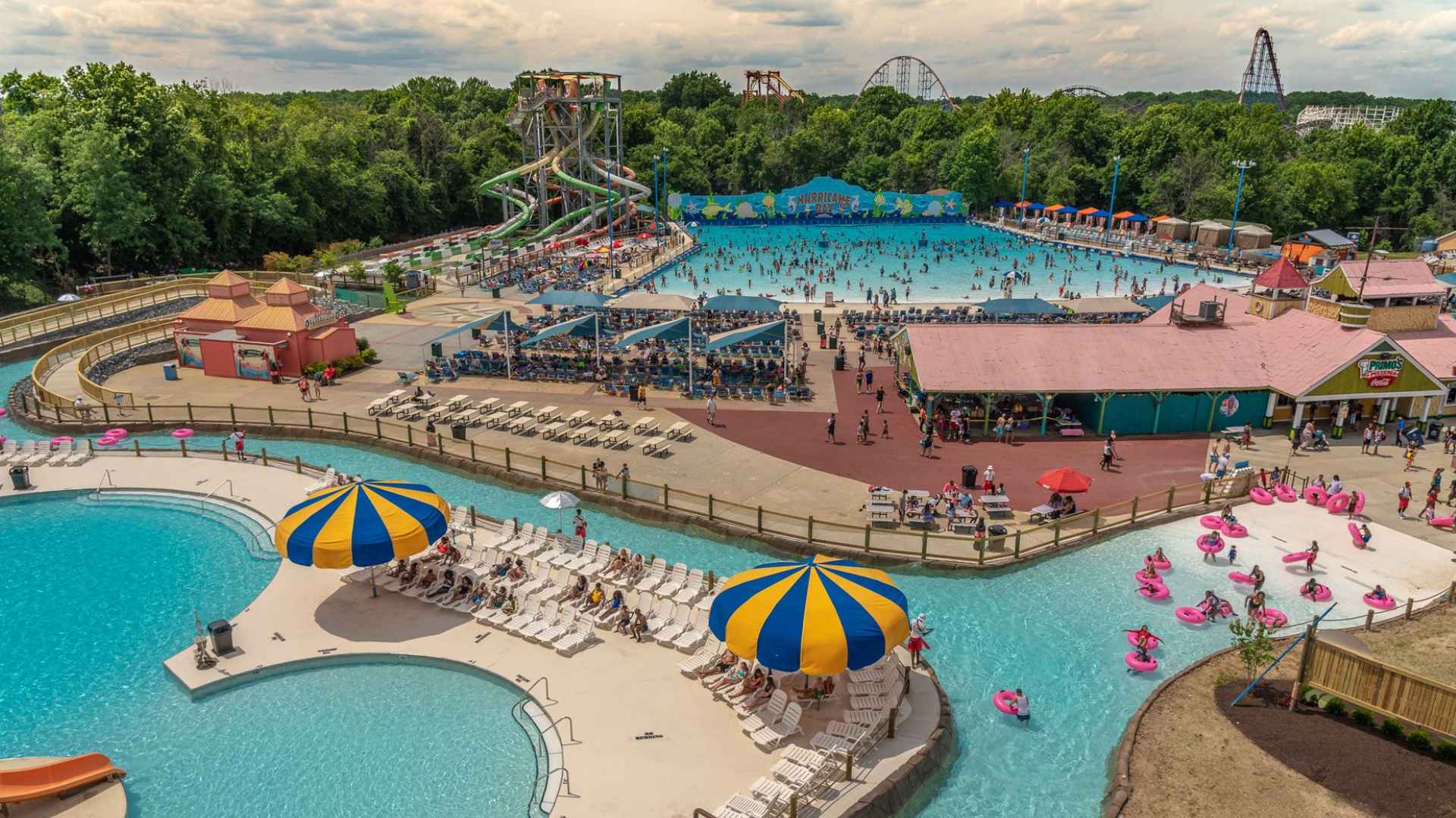 Aerial view of Hurricane Harbor at Six Flags America in Bowie, Maryland, featuring a busy wave pool, water slides and a winding lazy river.