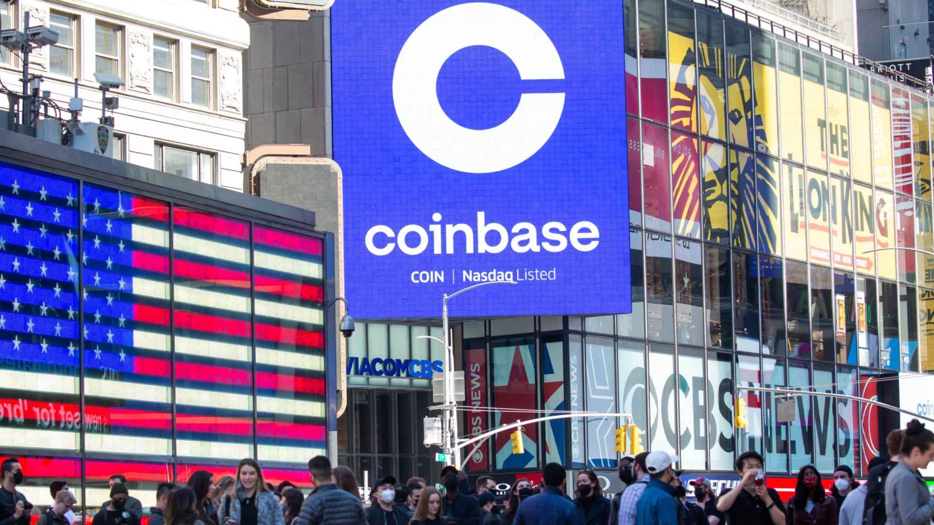 Coinbase logo on Times Square billboard above street crowd after $400 million breach reimbursement plan announcement