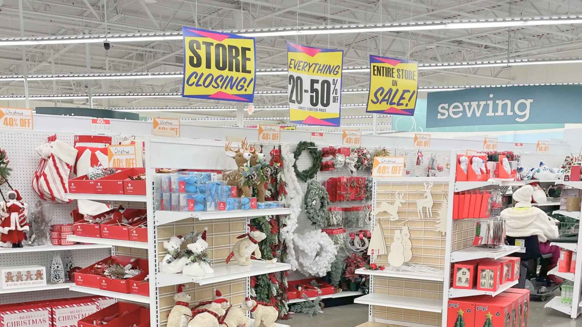 Interior of iconic textile chain Joann store with “Store Closing” and 20–50 % off signs above discounted Christmas décor.