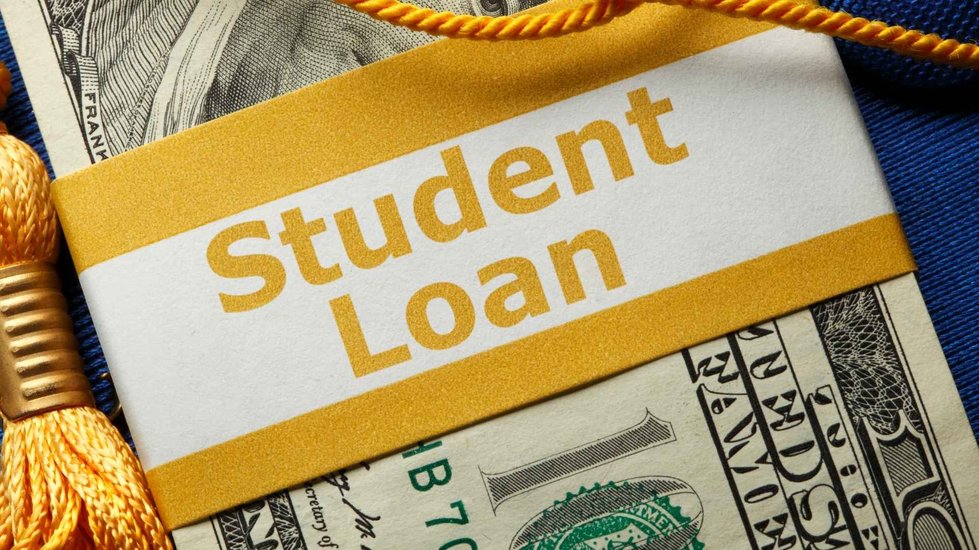 Close-up of a “Student Loan” label wrapped around U.S. dollar bills, symbolizing resumed federal debt collections