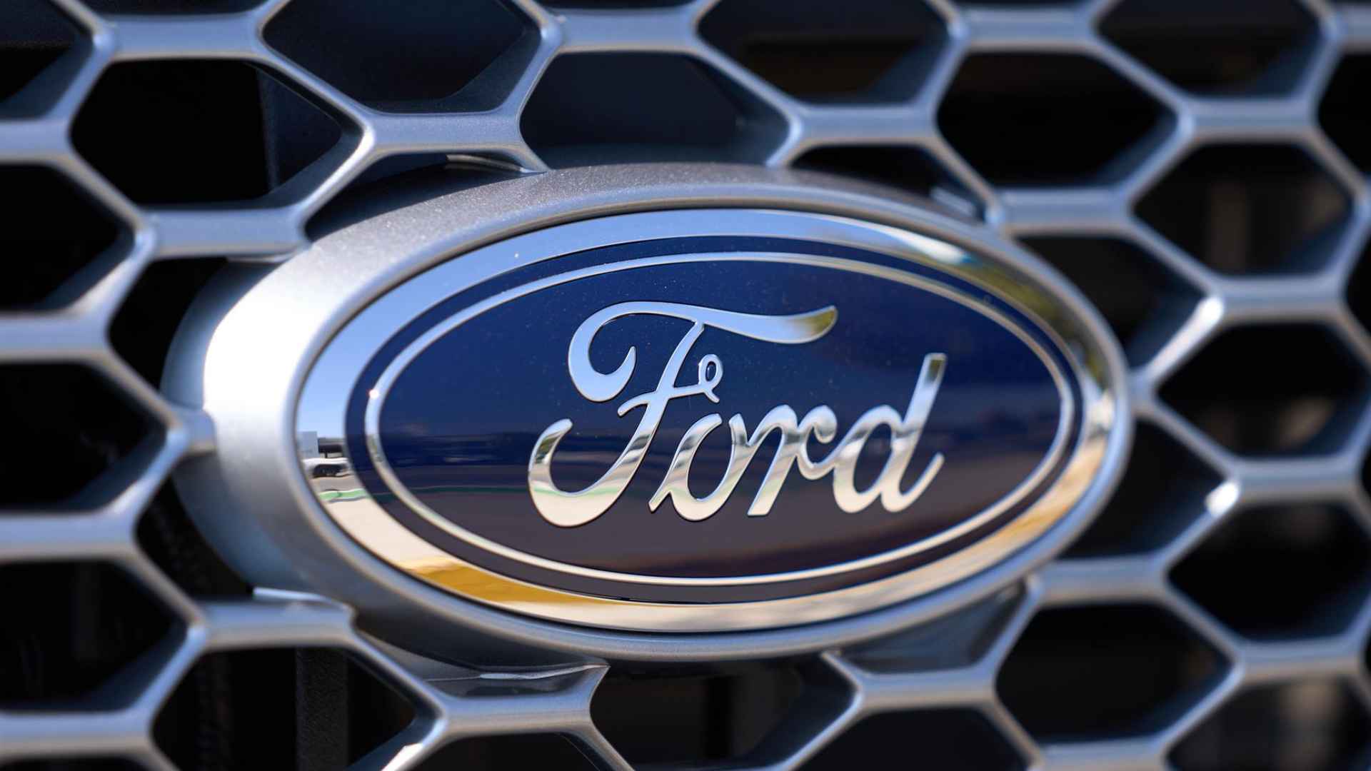 Ford logo on grille highlighting recall over brake and rear-camera defects in 2015-2018 models