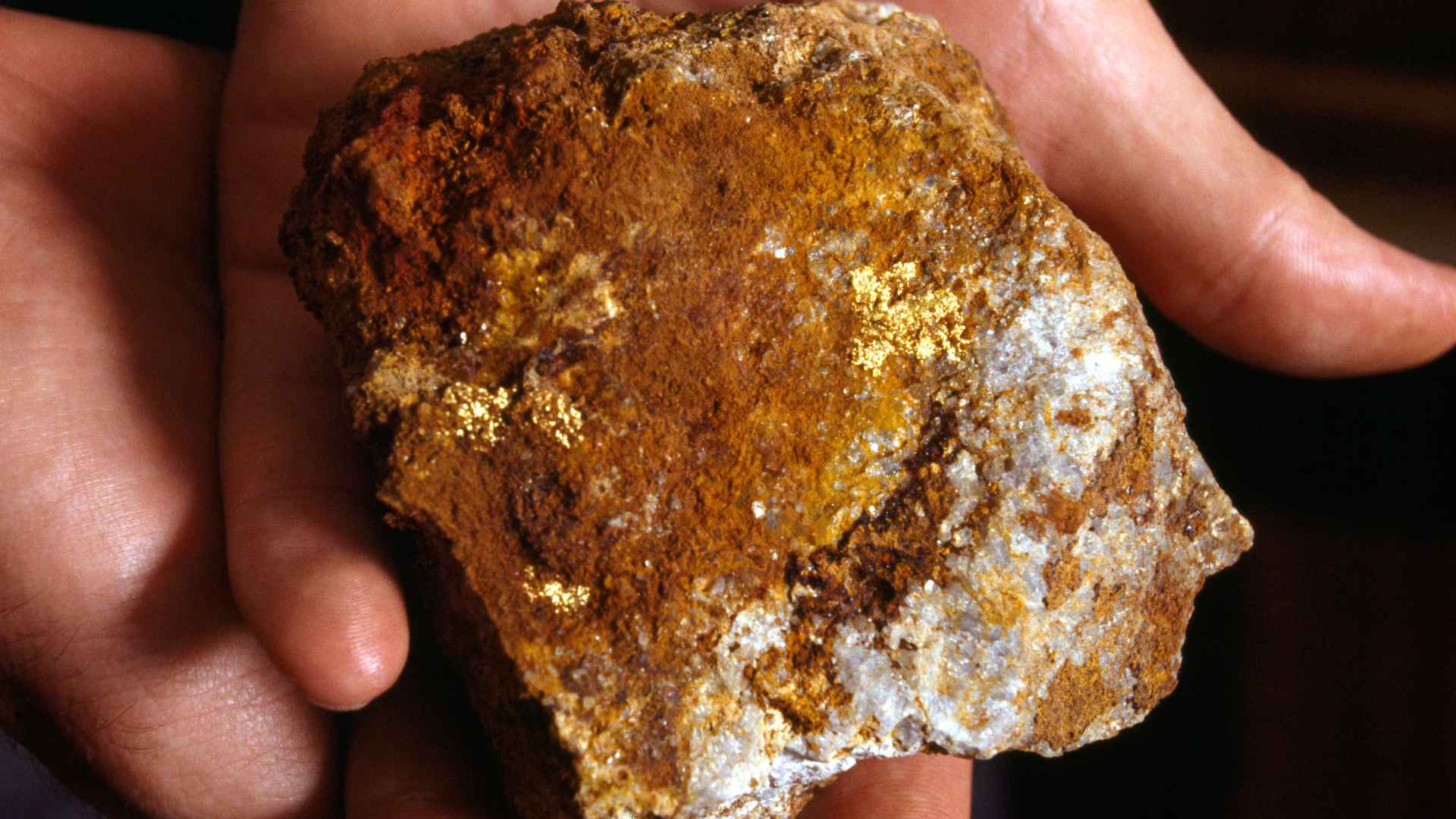 Close-up of geologist holding high-grade gold ore sample from Pingjiang, Hunan Province, central China, part of US$80 billion discovery.
