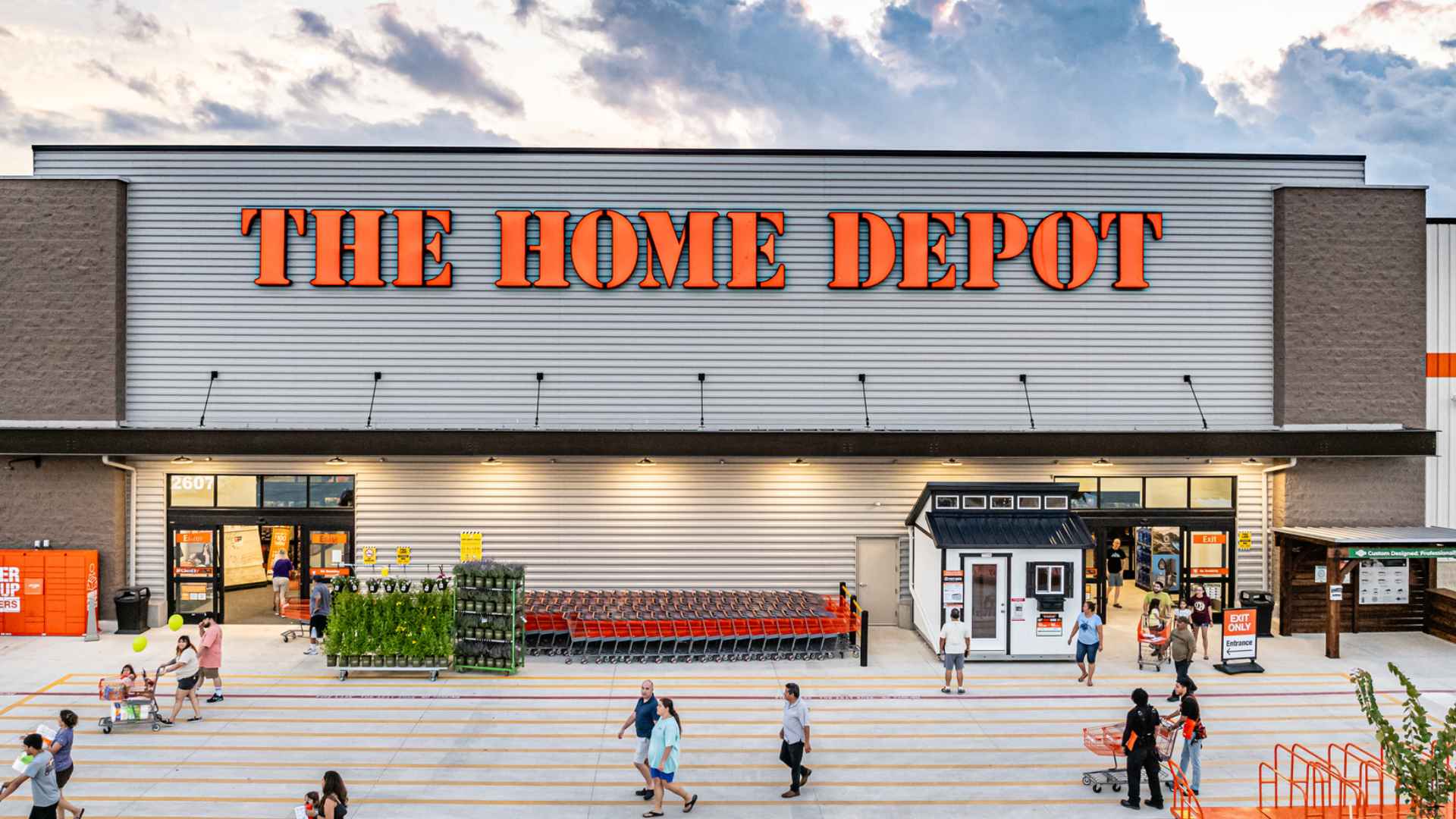 Home Depot exterior with shoppers and carts outside, reflecting retailer at center of DEI policy controversy.