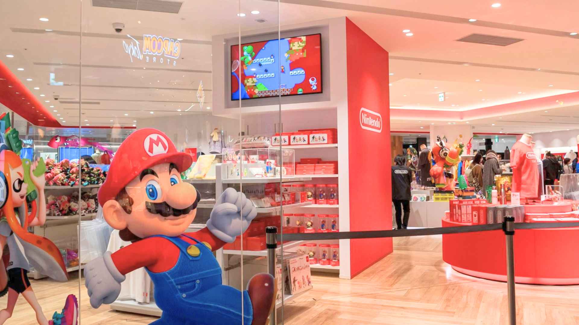 Nintendo store interior with life-size Mario, bright displays and exclusive collectibles, hinting at large crowds for Fukuoka opening in 2025.