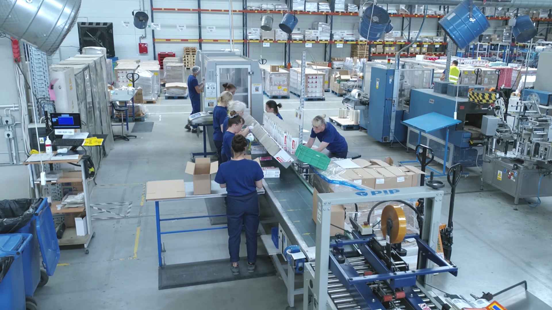 Workers on a packaging line inside a Wisconsin manufacturing plant slated for summer closure and 100 layoffs