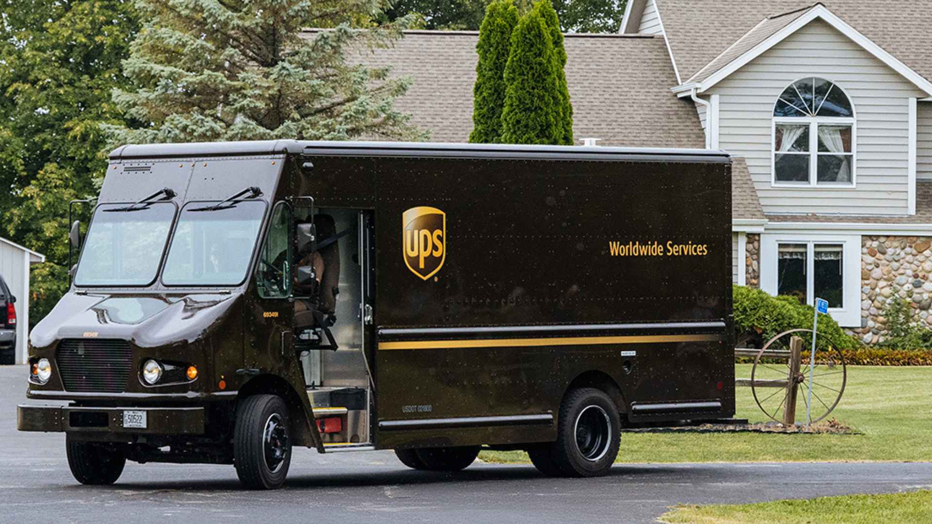UPS Worldwide Services truck turns into a suburban driveway outside a Pennsylvania home amid upcoming facility closures.