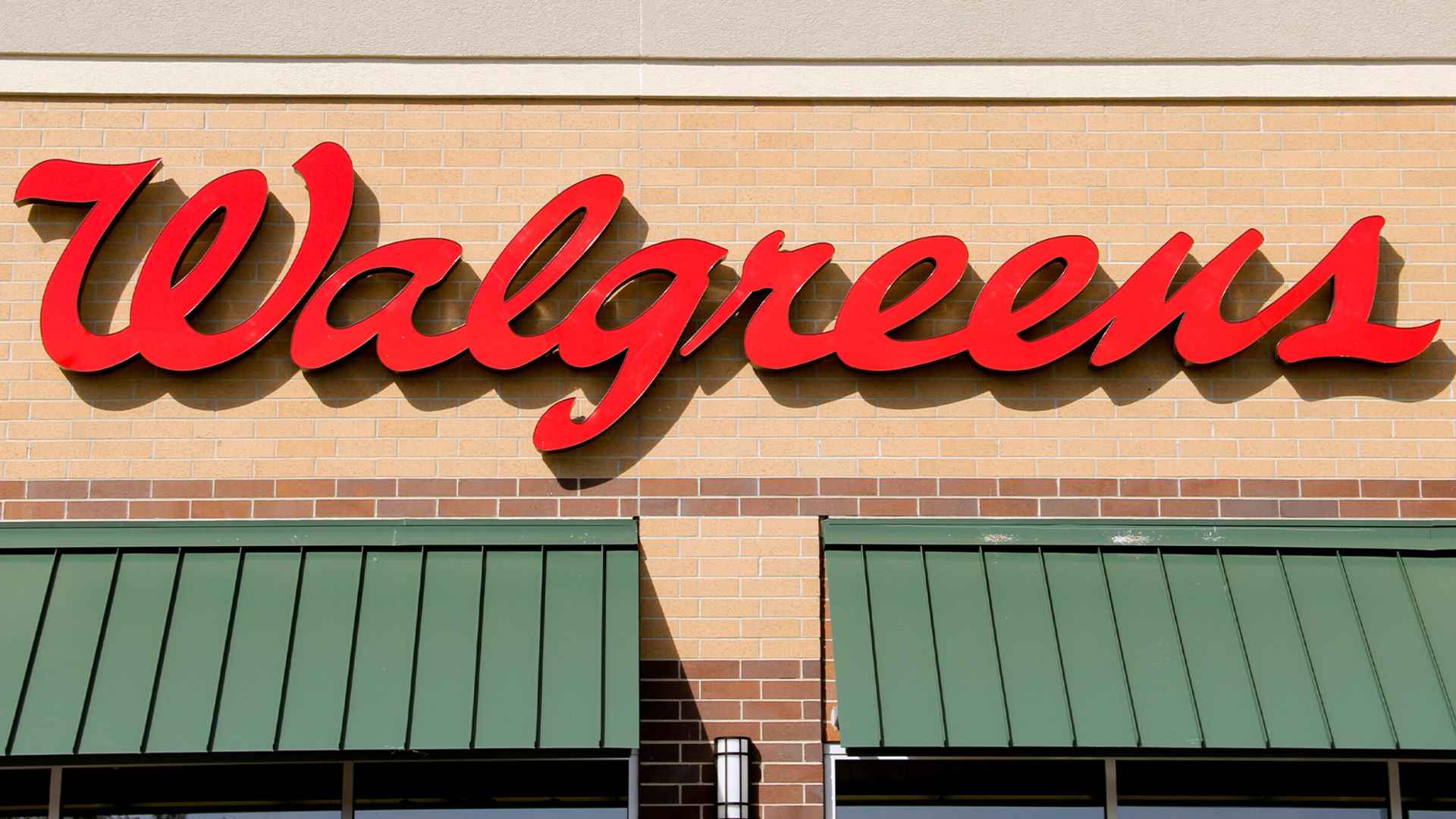 Walgreens storefront with red script logo and green awnings, illustrating pharmacies that are closing in several U.S. states this month.