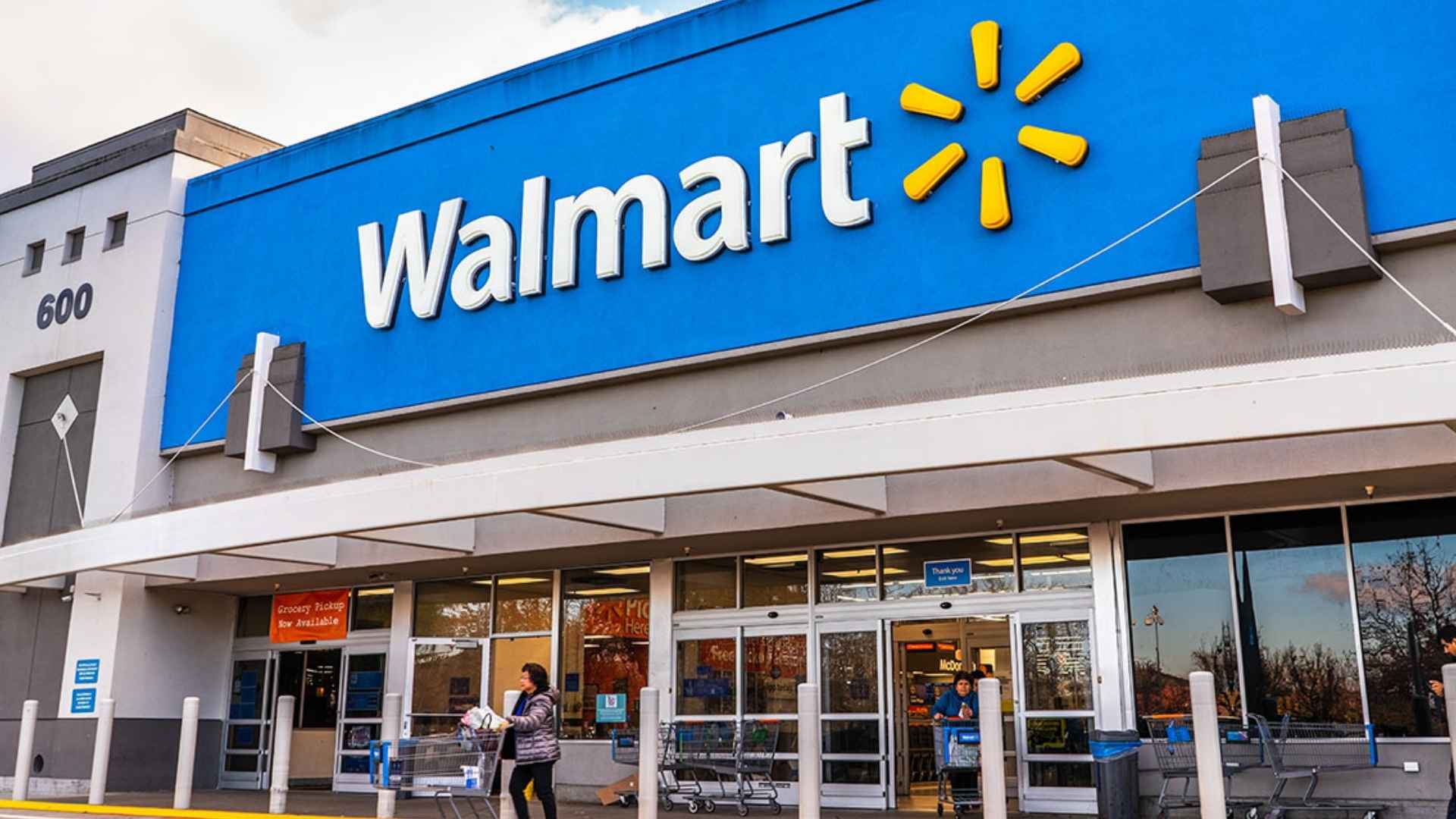 Exterior of a Walmart store with shoppers at the entrance—one of five California locations scheduled to close by 2025.