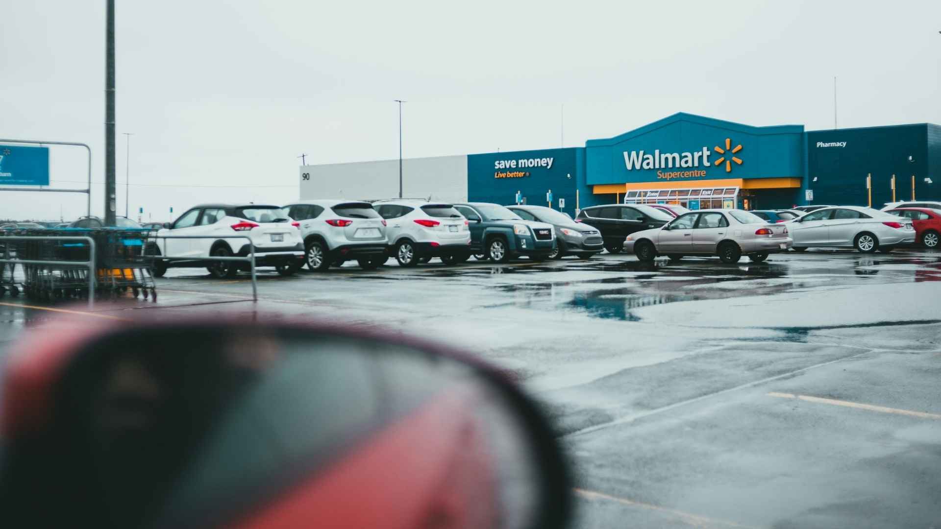 Row of cars in Walmart Keeaumoku parking lot on a rainy day; store to enforce new $48 fines and towing after 3-hour limit