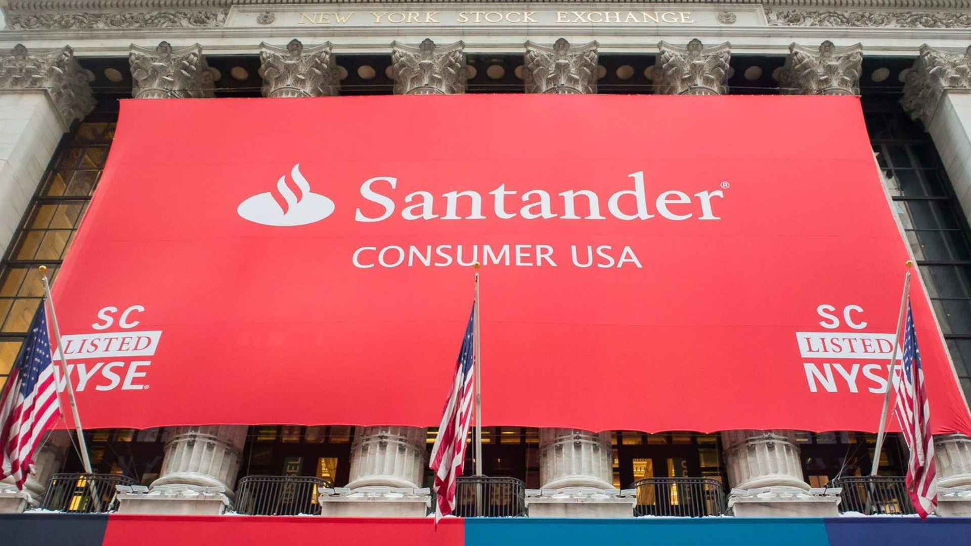 Large red “Santander Consumer USA” banner draped over the New York Stock Exchange, symbolizing planned closure of 20 U.S. branches.