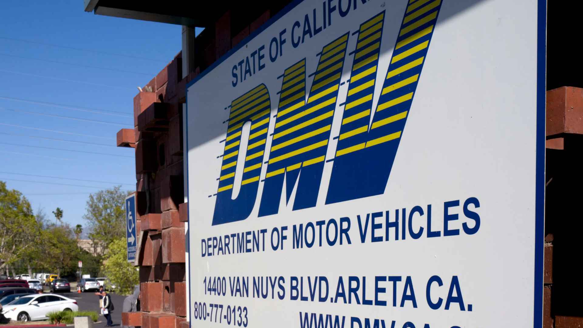 California DMV sign at Arleta office, highlighting agency behind 2026 rollout of new 000AAA0 license-plate format
