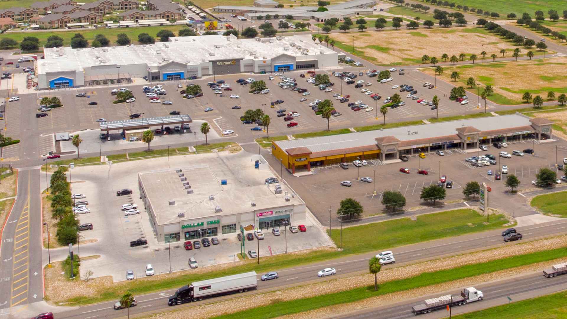 Aerial view of Peñitas Crossing site in Peñitas, Texas, showing Walmart, Dollar Tree, strip-mall buildings and parking lots slated for new discount stores