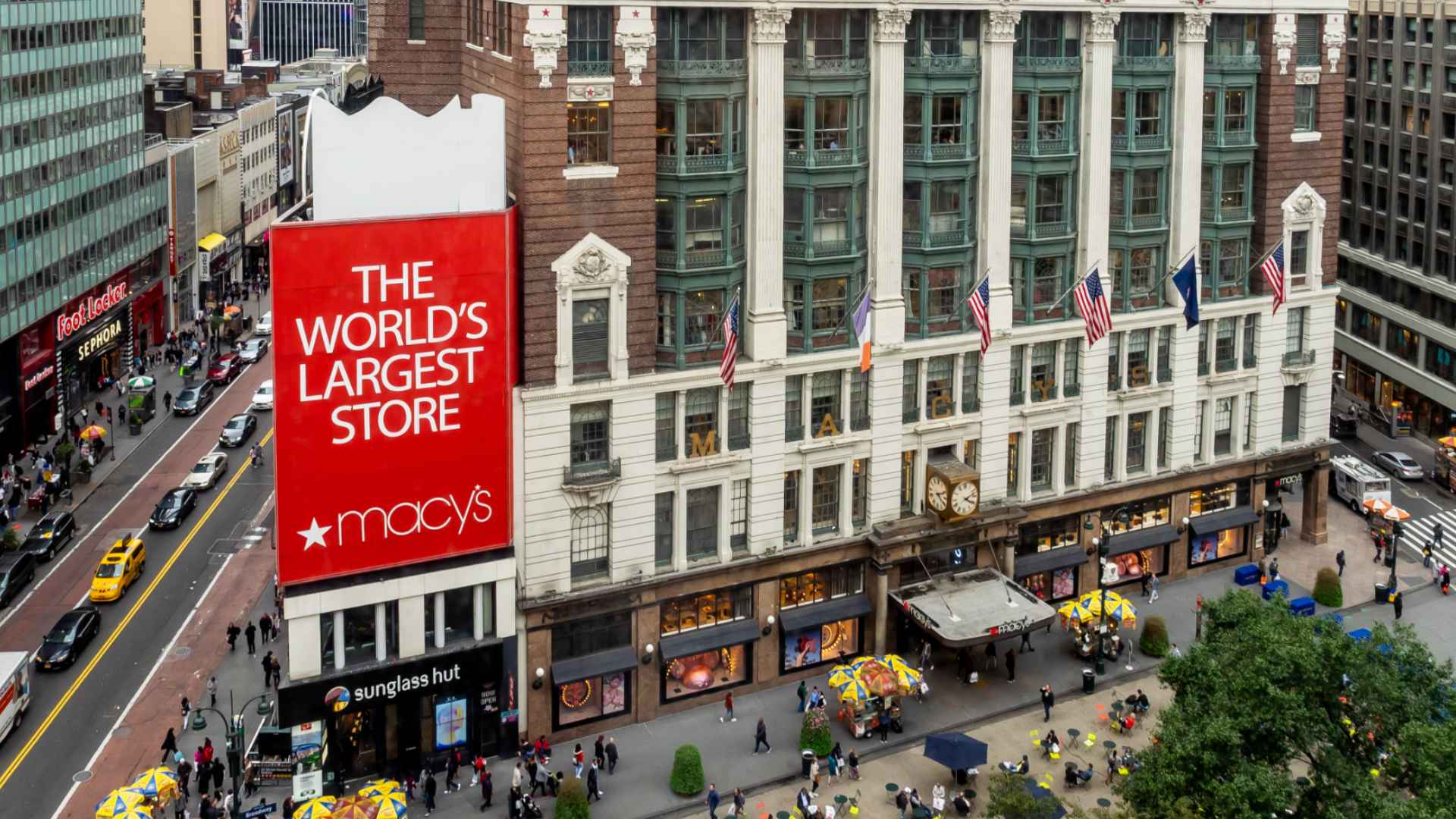Macy’s Herald Square flagship store exterior in New York City, “World’s Largest Store” sign and busy street scene below