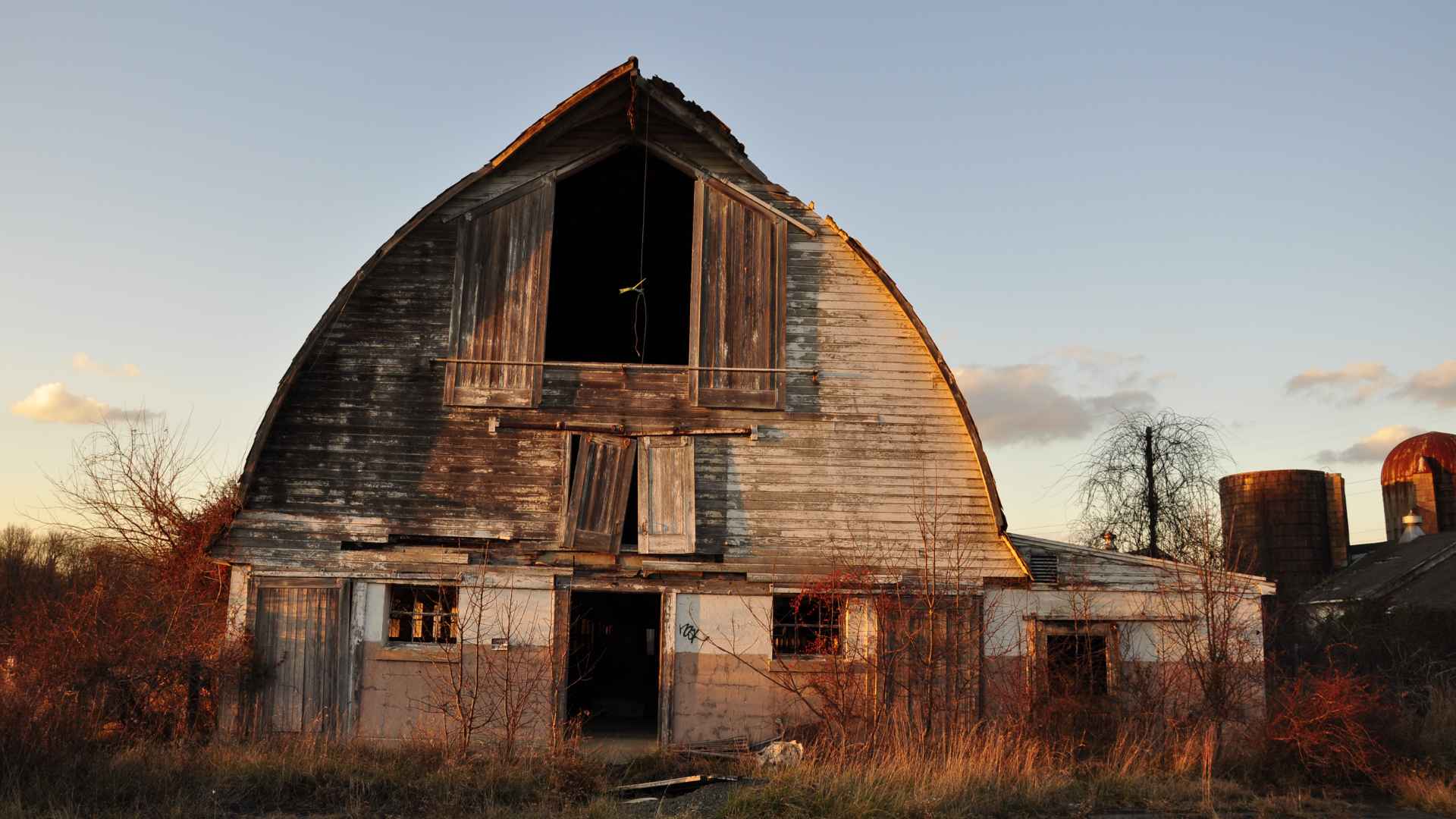 Weathered wooden barn on abandoned Kansas farm where buyer Silas uncovered dozens of hidden classic cars during cleanup