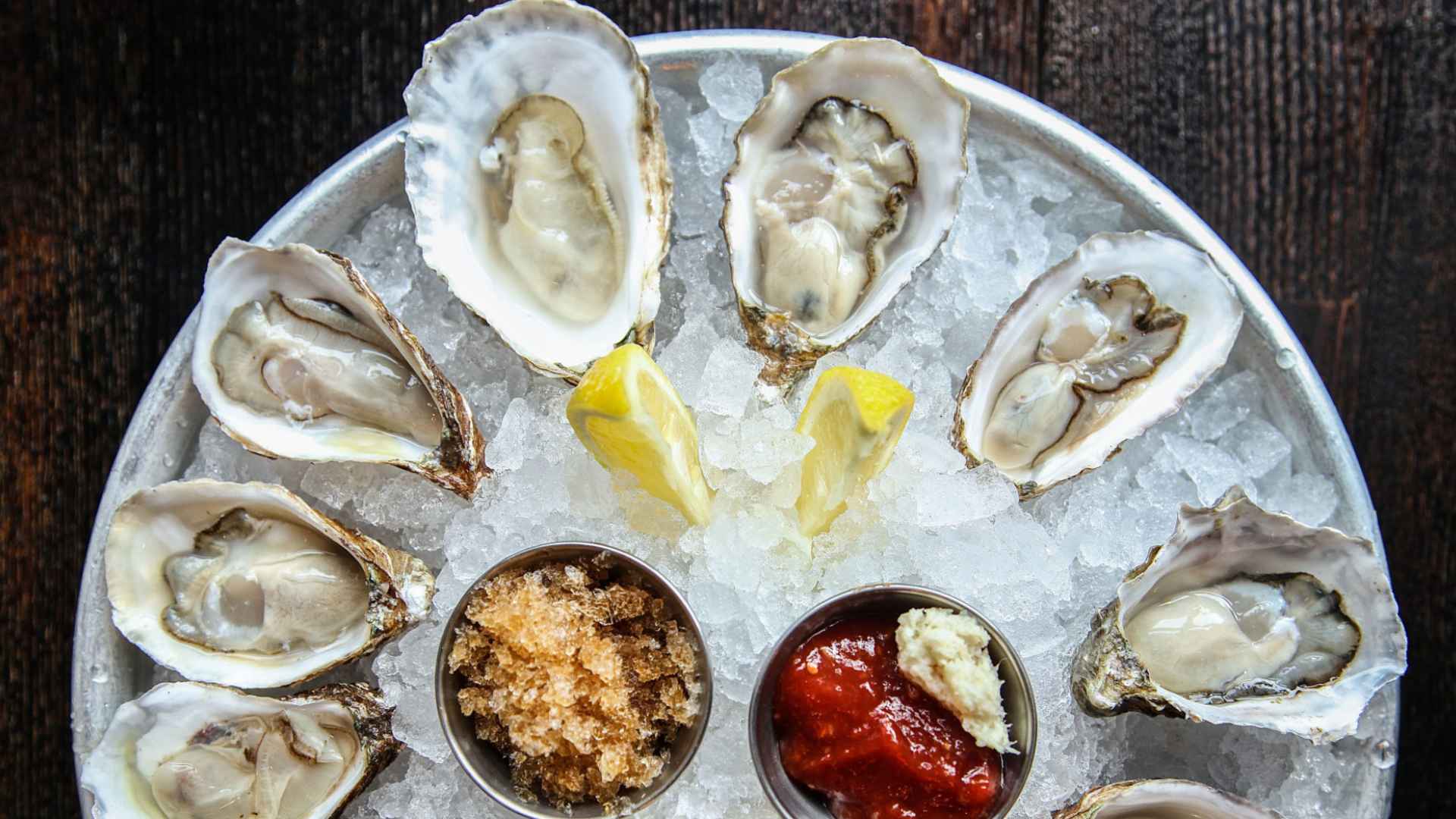 Fresh oysters on ice with lemon wedges and dipping sauces at Catch 35 in Naperville, served weeks before its June 28 closure.