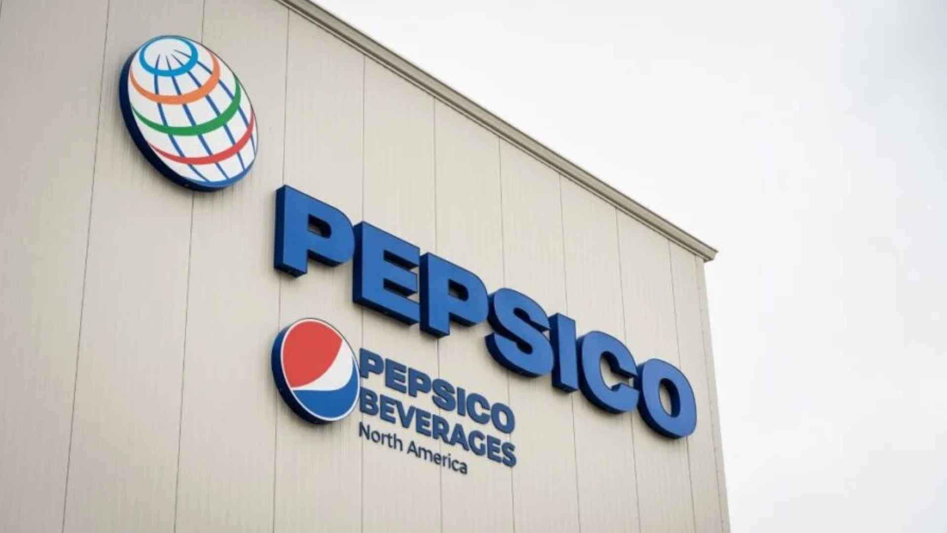 Exterior view of PepsiCo Beverages North America logo on Liberty, NY snack factory slated for closure, eliminating 300 local jobs.