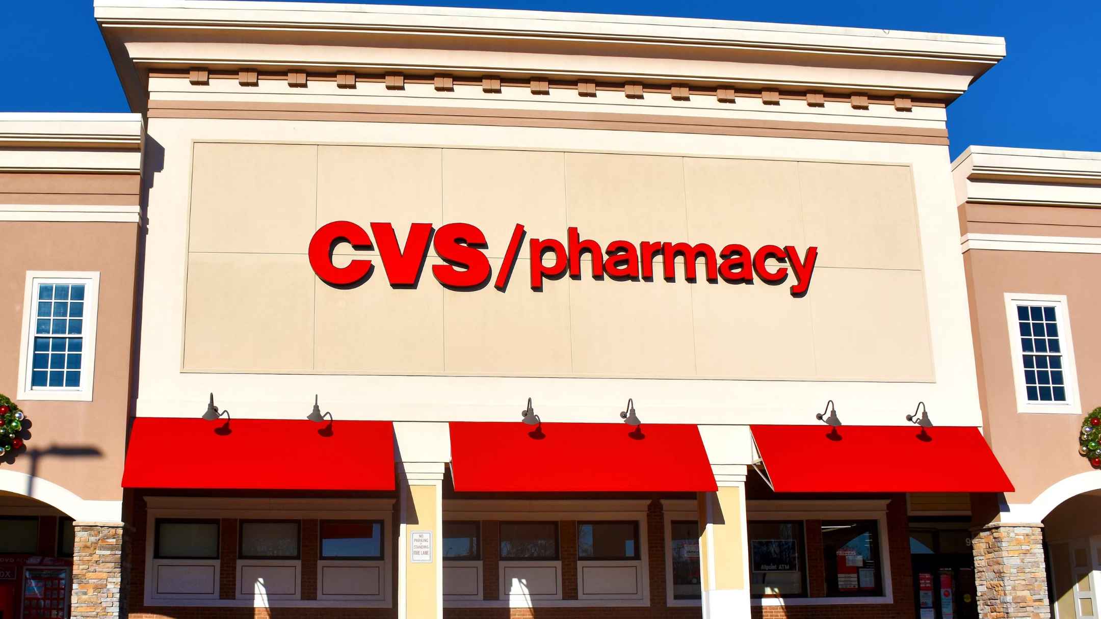 Exterior of a CVS Pharmacy with red logo and awnings, illustrating one of more than 250 U.S. stores set to close in 2025.