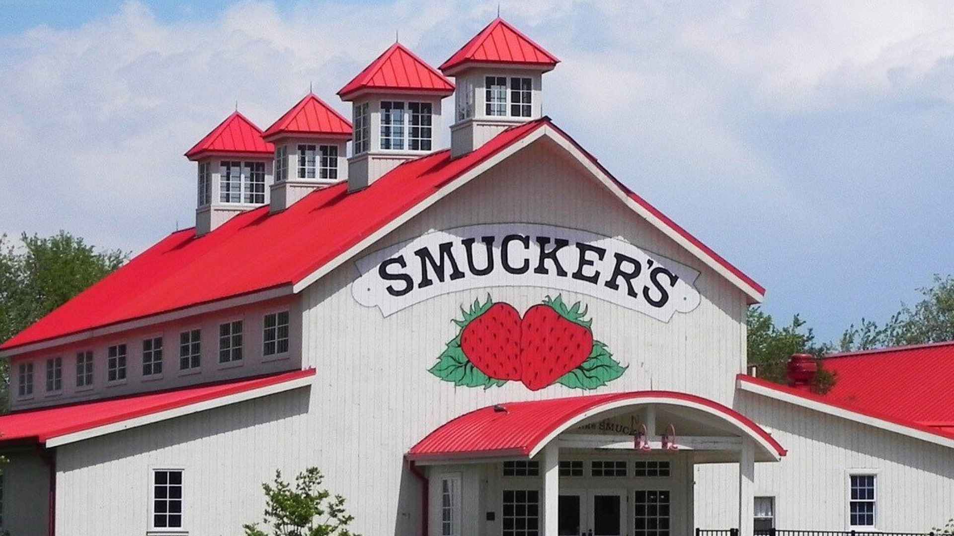 Exterior of Smucker’s white building with bright red roof in Indianapolis, slated to close by 2026, putting 371 jobs at risk.