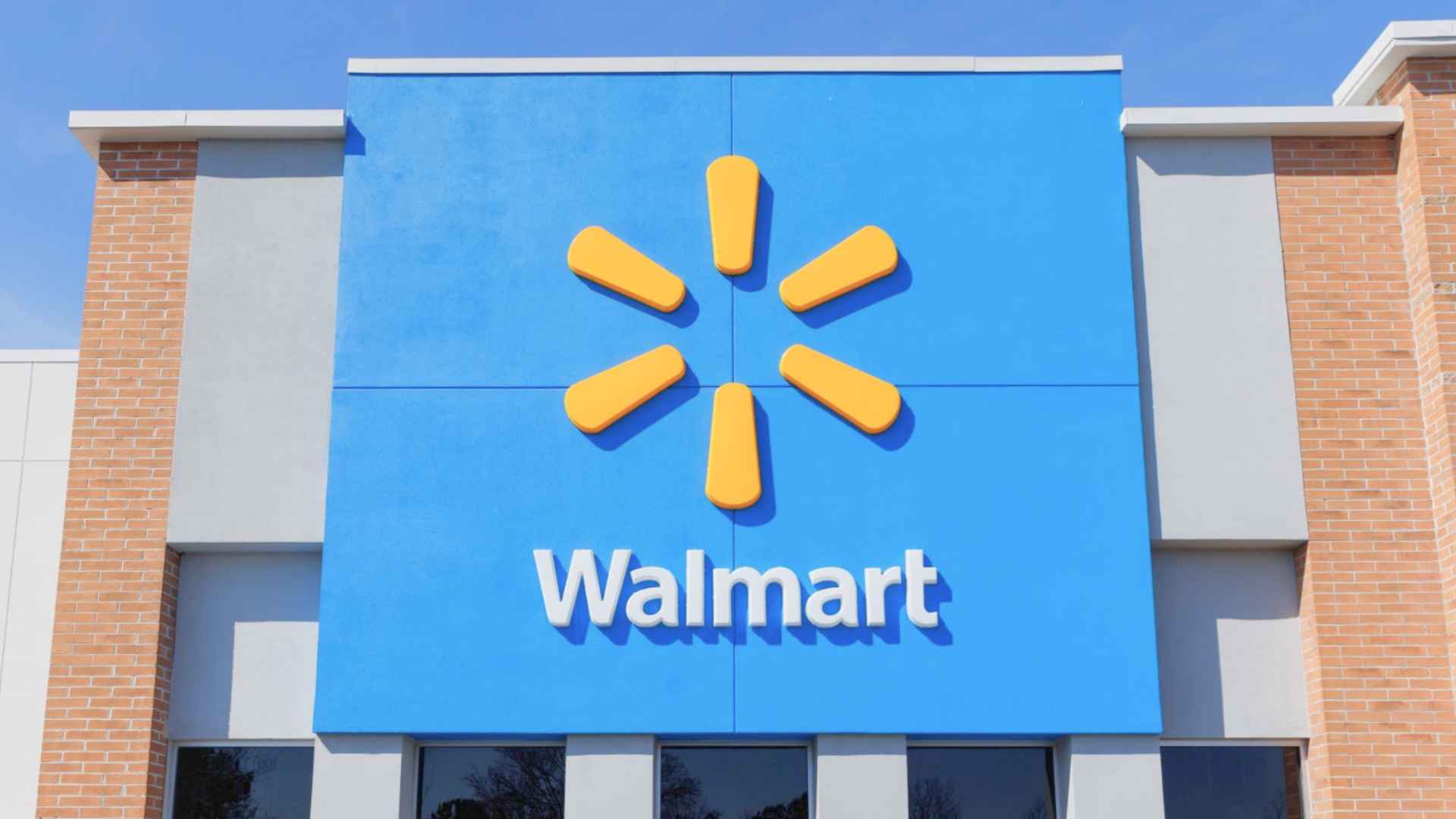 Walmart store exterior with signature blue facade and yellow spark logo above the entrance