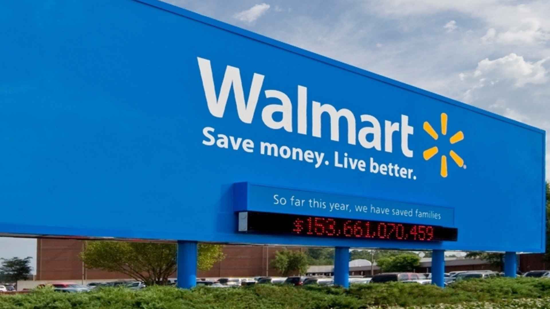 Walmart Supercenter sign with American flag waving against a blue sky outside a U.S. store
