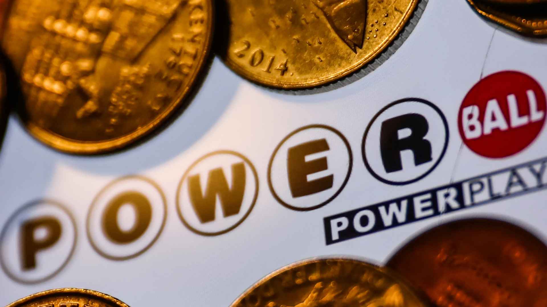 Gold coins on a Powerball ticket, highlighting the record jackpot of $526.5 million