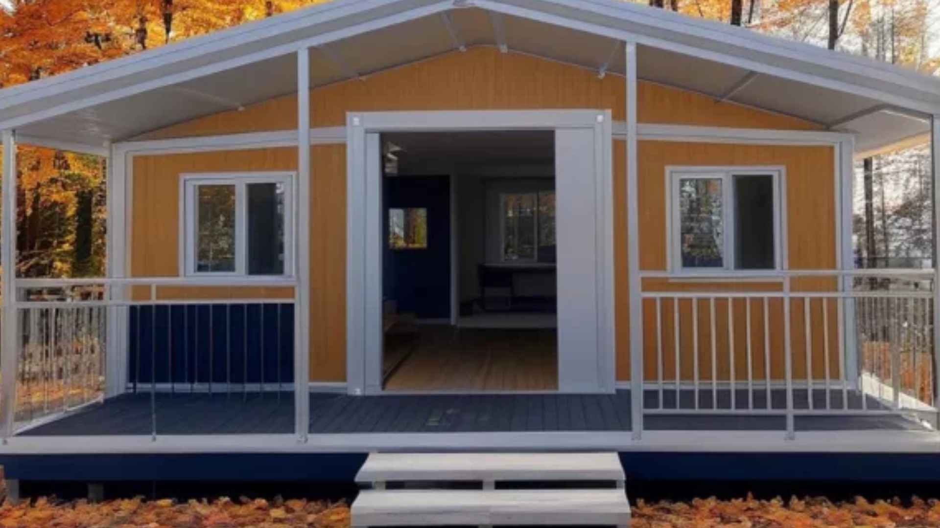 Rustic Amazon tiny house with two bedrooms, covered porch, and fall scenery priced at $11,100