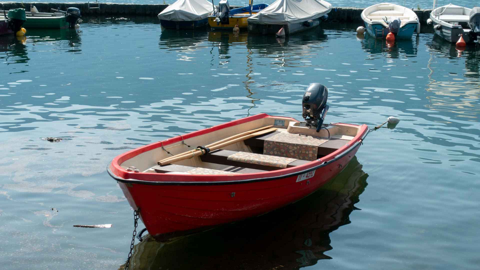 Small motorboat used daily by a father to cross the sea taking his children to school safely
