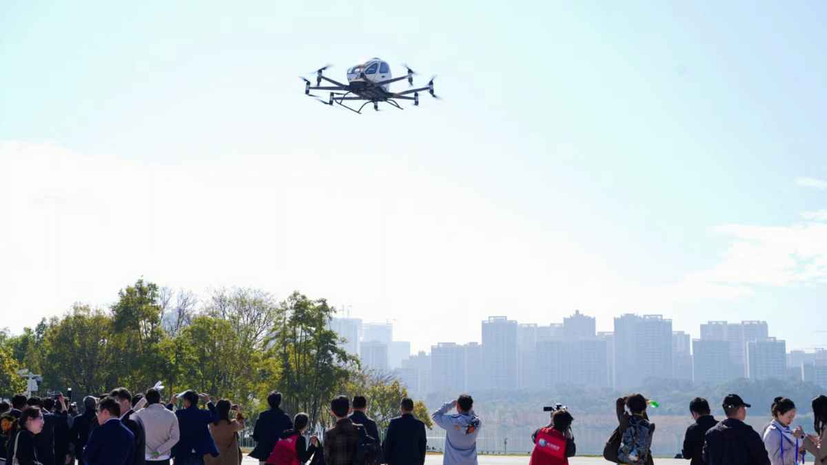 Flying taxi demonstration in China with city skyline in the background