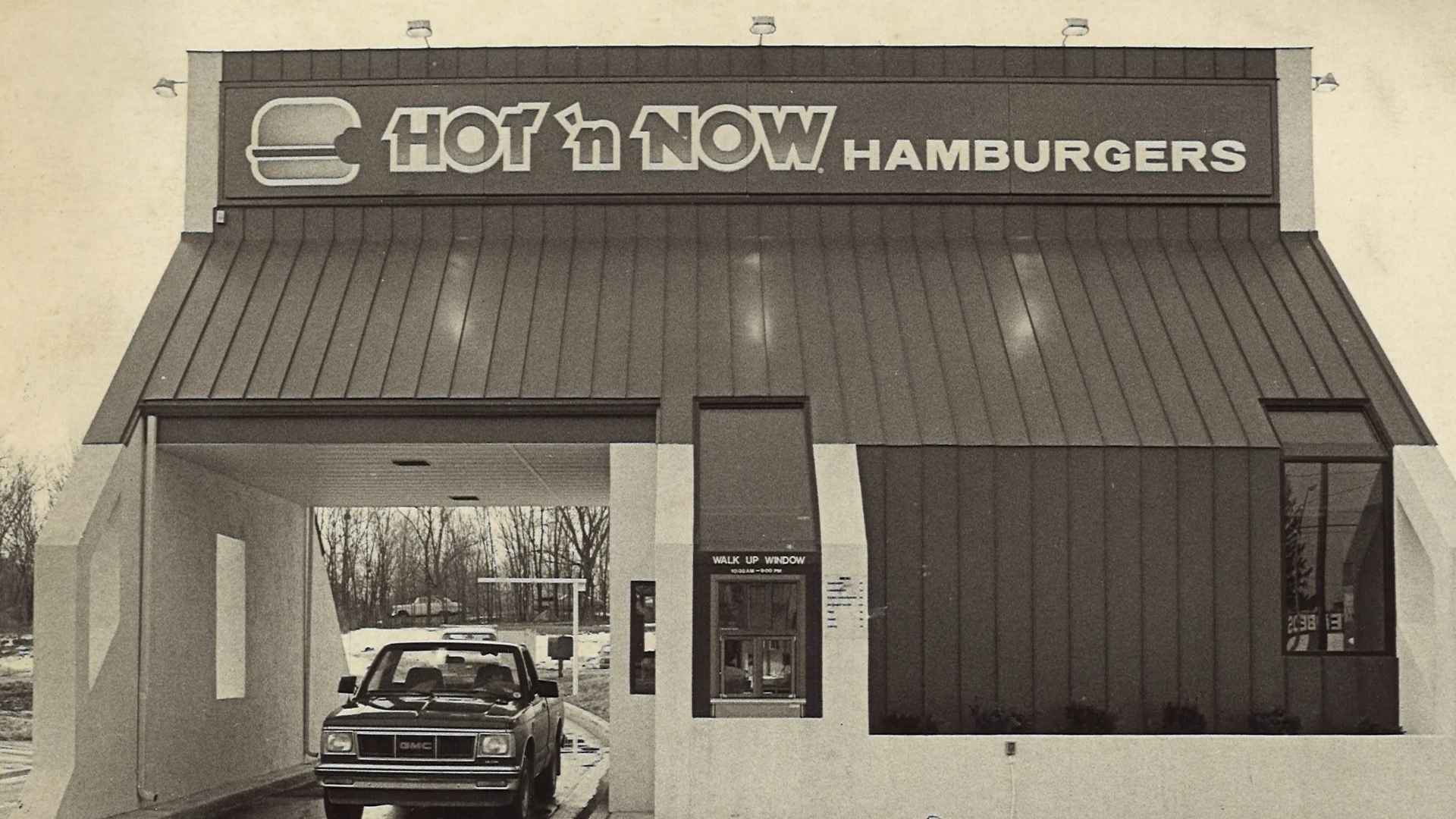 Vintage Hot ‘n Now Hamburgers drive-thru in Wayland Township, Michigan, showing classic pickup window before the chain’s bargain-price comeback.