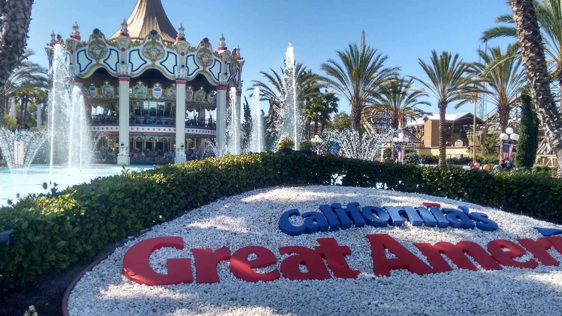 California's Great America entrance with fountains and carousel on a sunny day in Santa Clara.