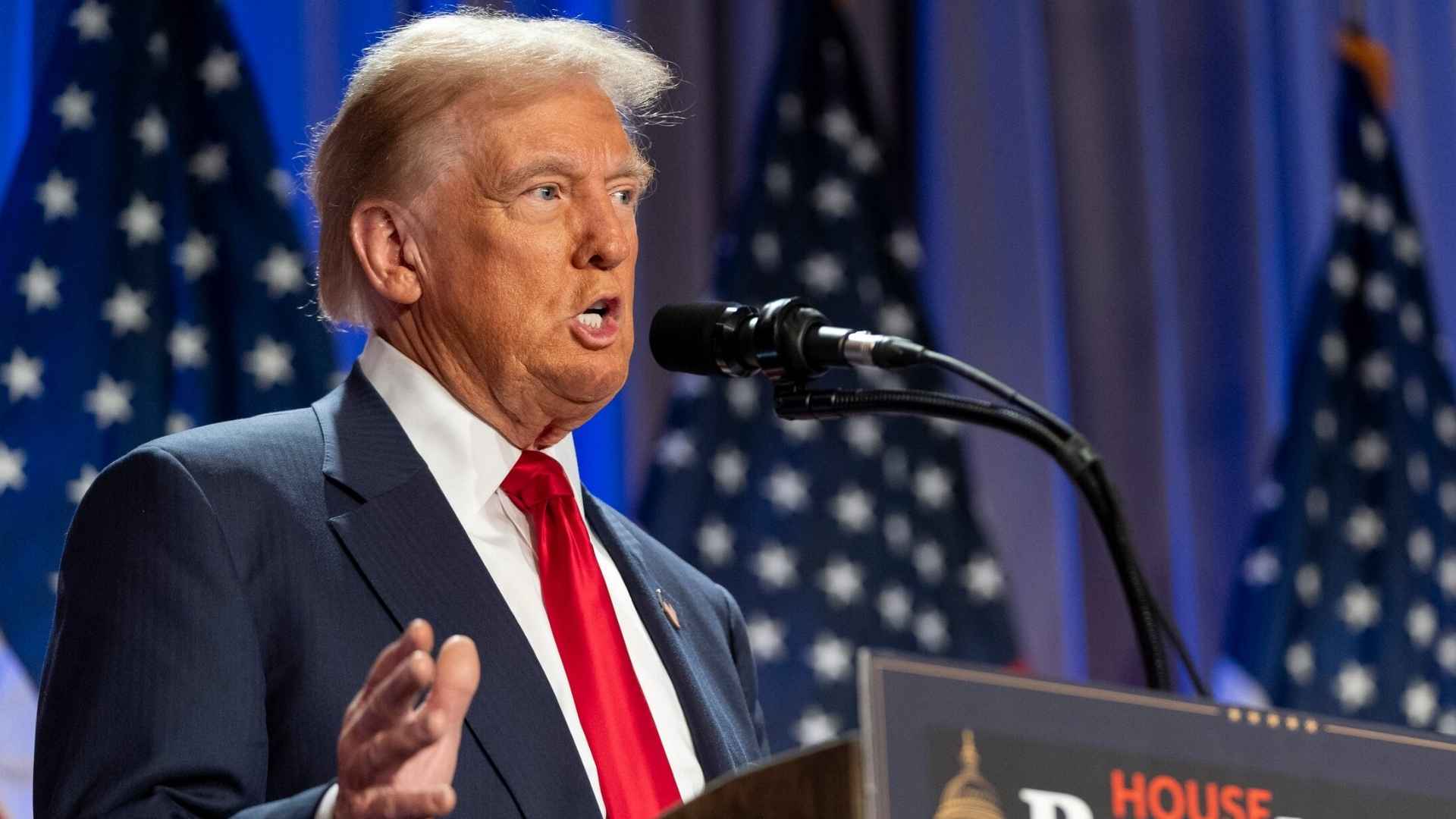 Donald Trump speaks at a podium with American flags behind him during an official speech
