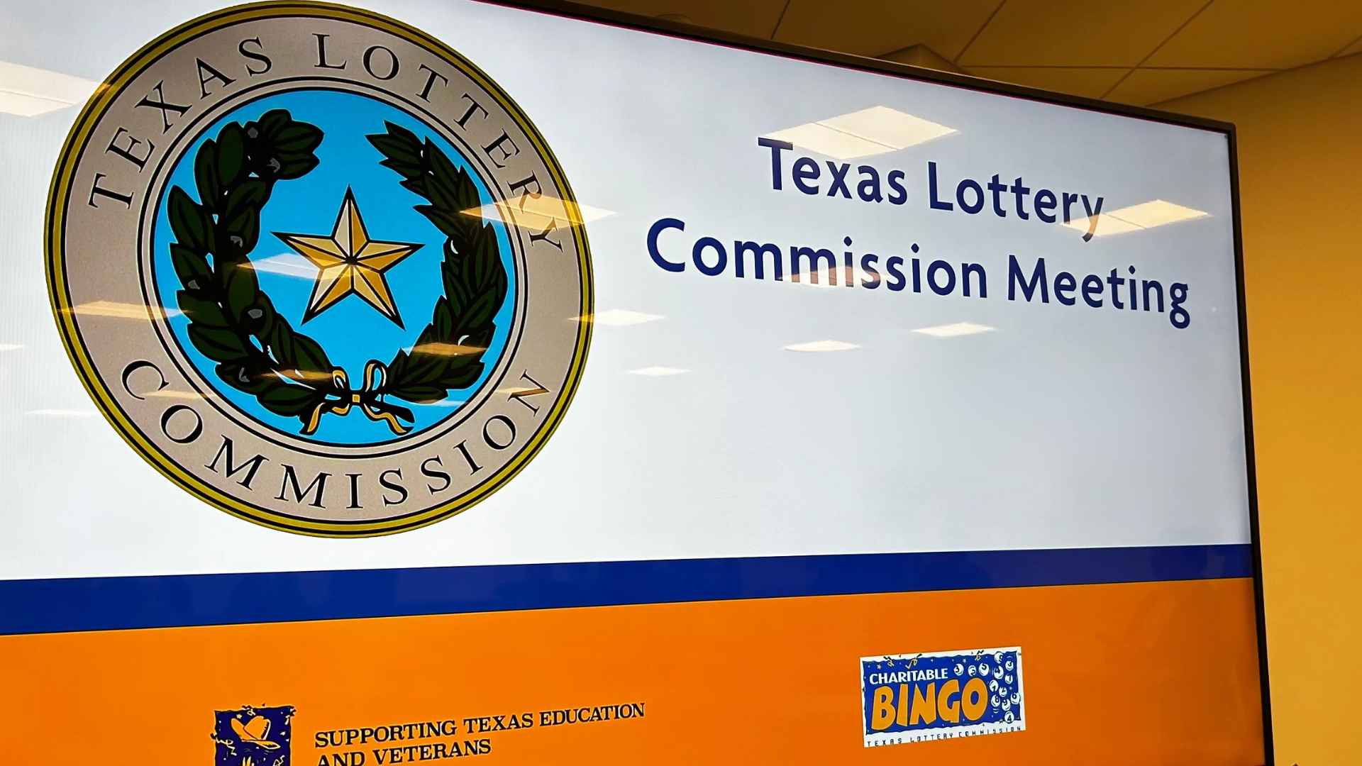 Texas Lottery Commission seal and meeting sign related to $83.5 million jackpot dispute