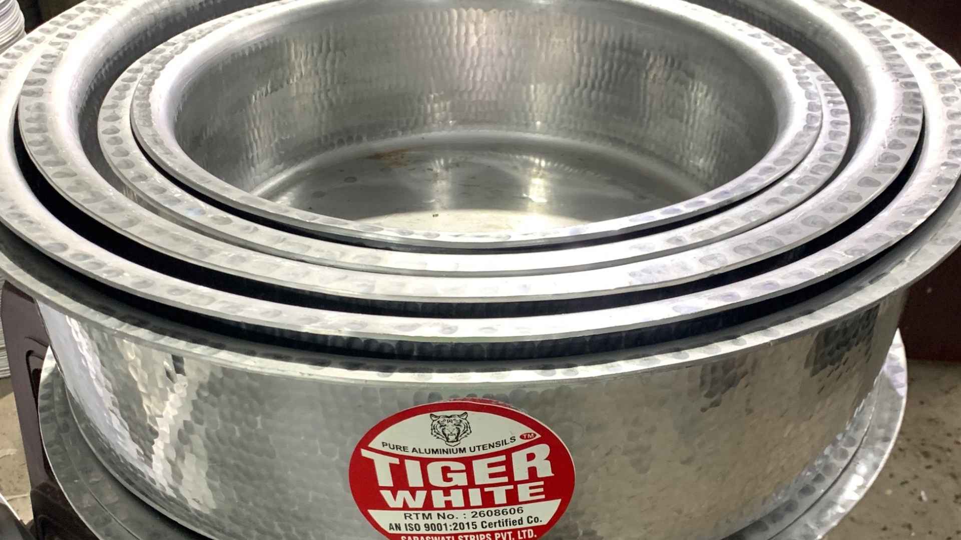 Stack of Tiger White aluminum cookware pots linked to FDA lead warning