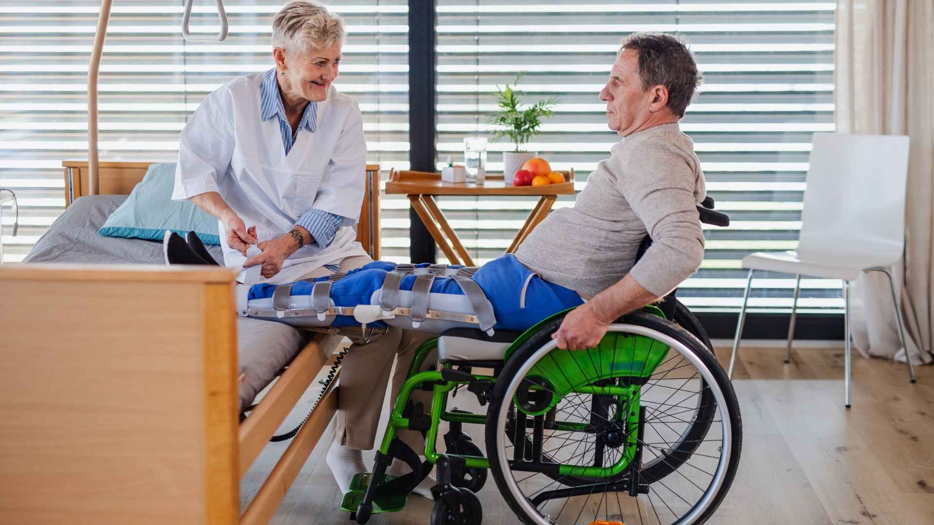 Disabled man in wheelchair receiving care from a healthcare worker at home