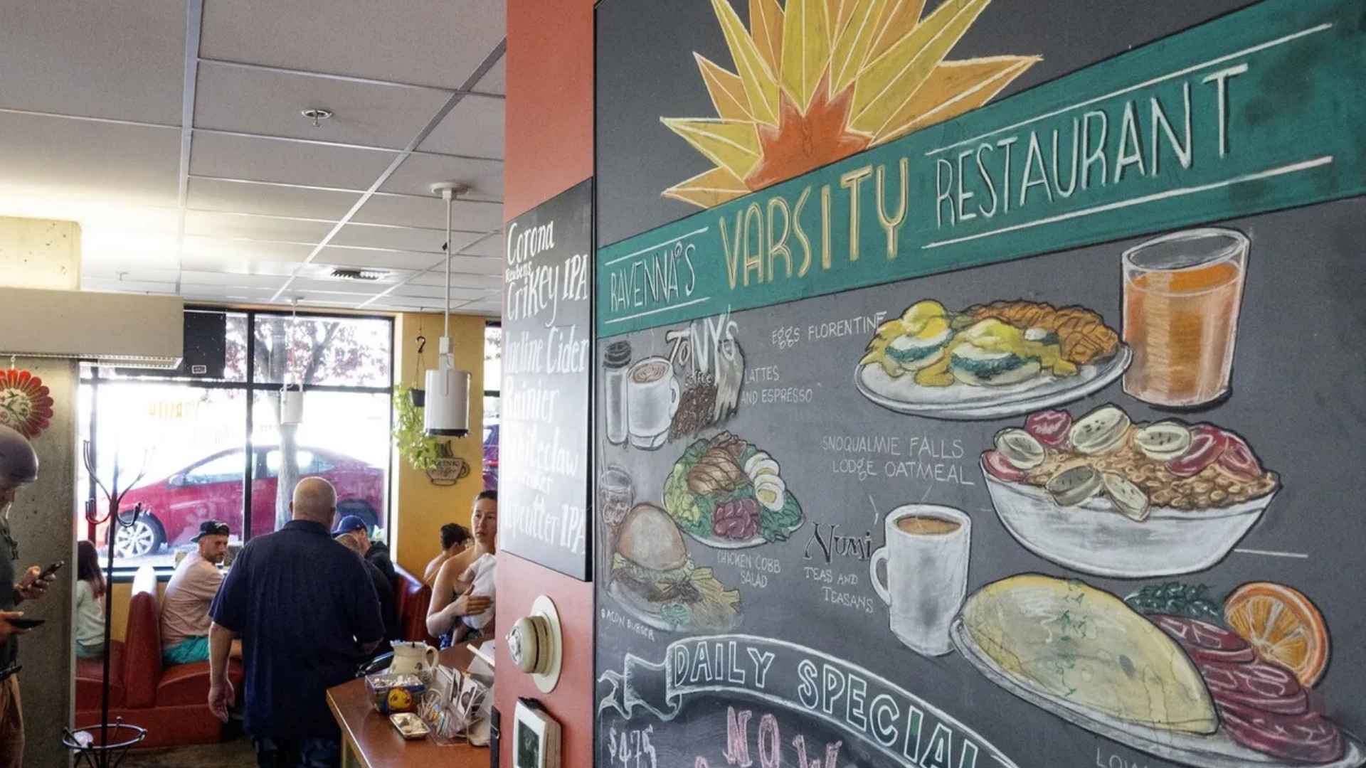 Interior of Ravenna Varsity Restaurant showing its chalkboard menu and patrons seated at booths during the breakfast rush