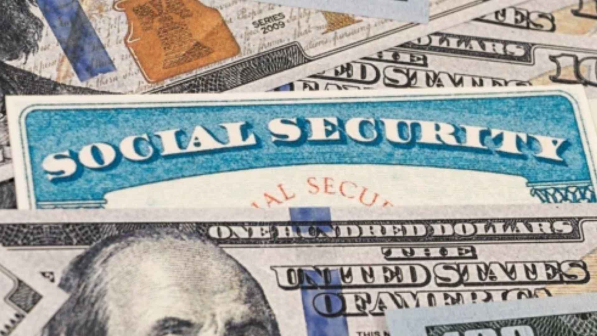 Social Security card on top of U.S. hundred-dollar bills representing financial challenges for retirees in 2026