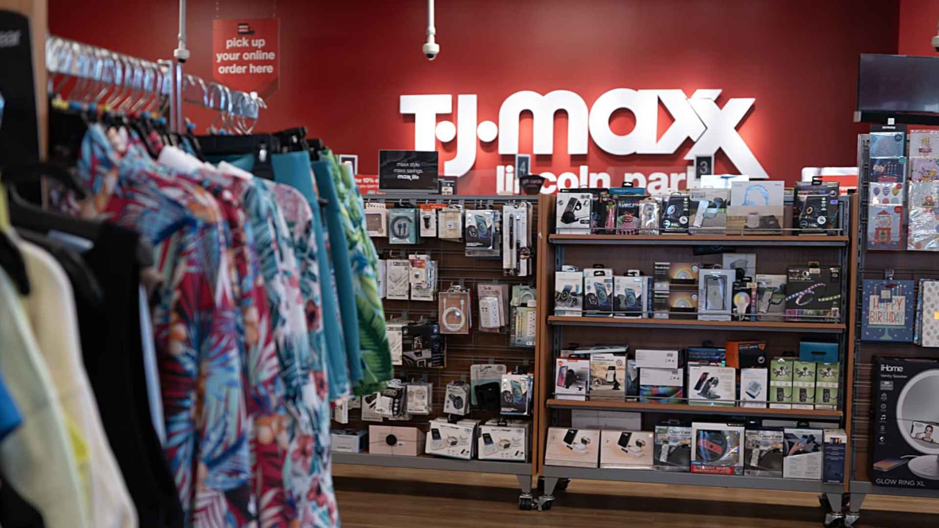 Interior view of a TJ Maxx store featuring clothing racks and electronic accessories ahead of new store openings.