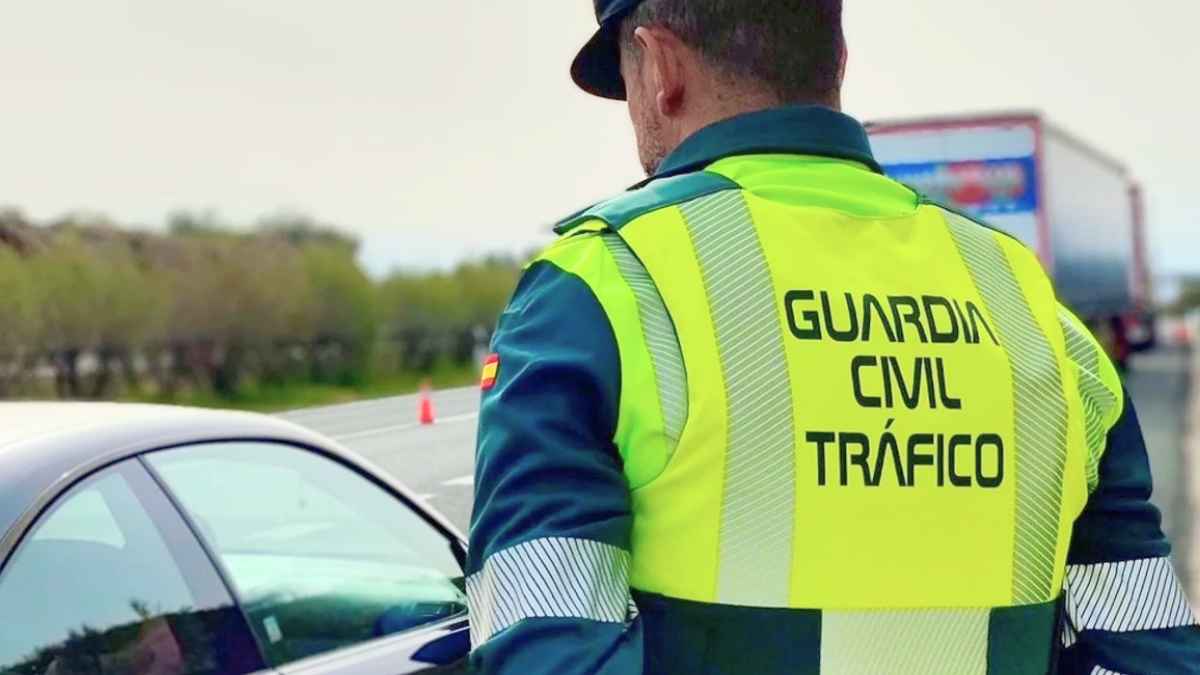Agente de la Guardia Civil de Tráfico revisando un coche en carretera para comprobar el dispositivo obligatorio V16