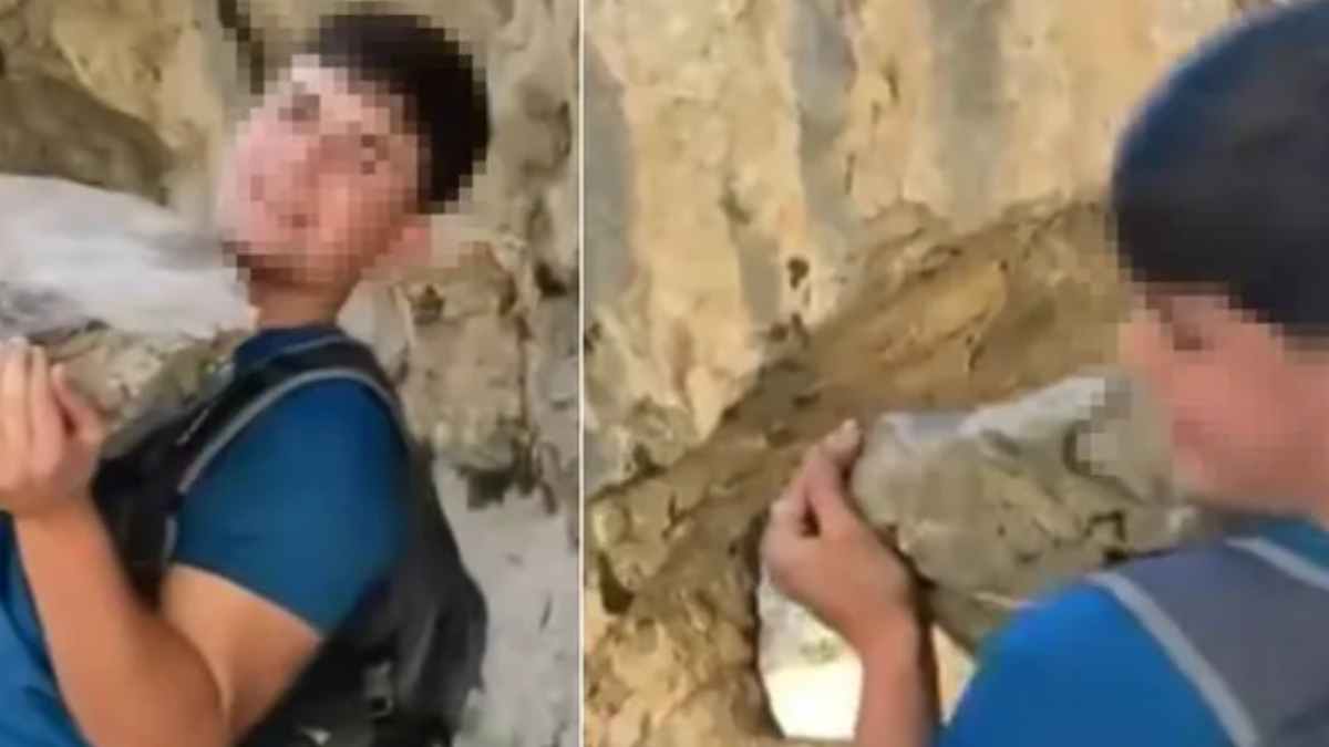 Influencer sujetando una roca gigante antes de lanzarla en la Ruta del Cares, desfiladero asturiano