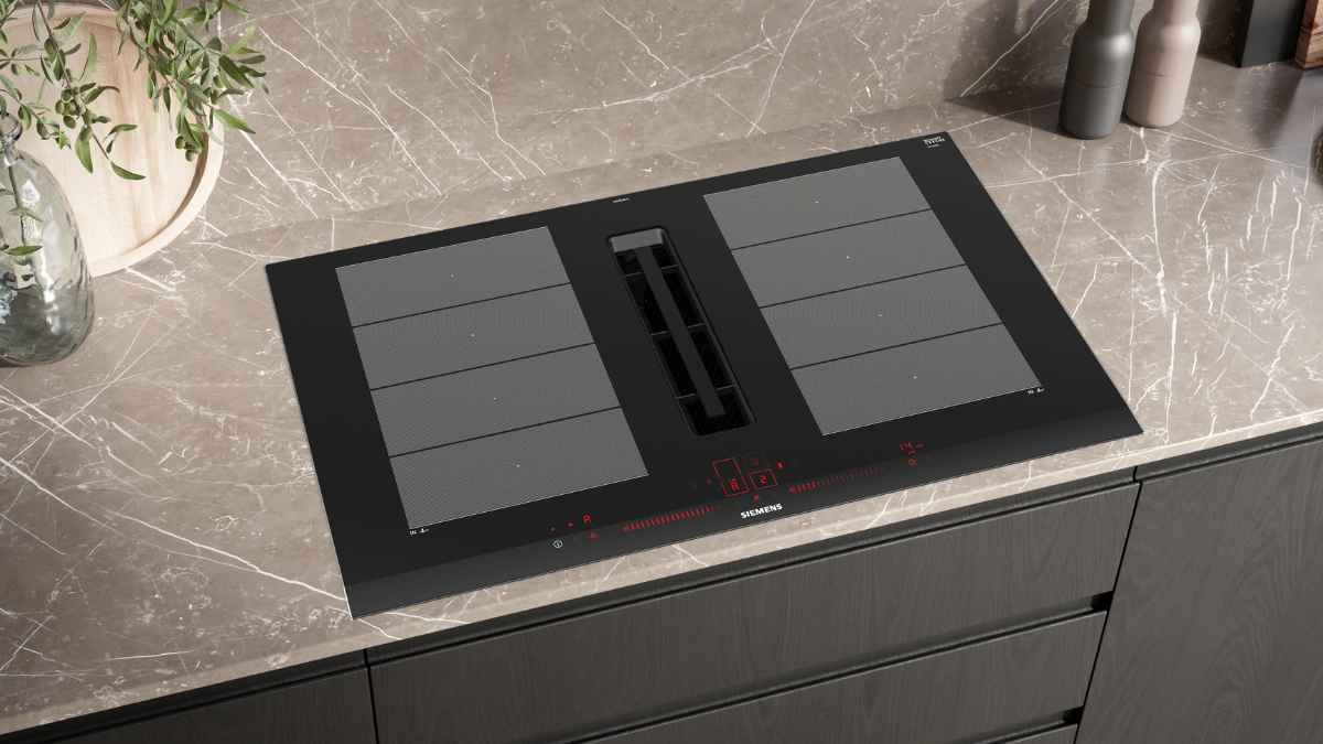 Placa de inducción Siemens con extractor integrado instalada en encimera de cocina moderna