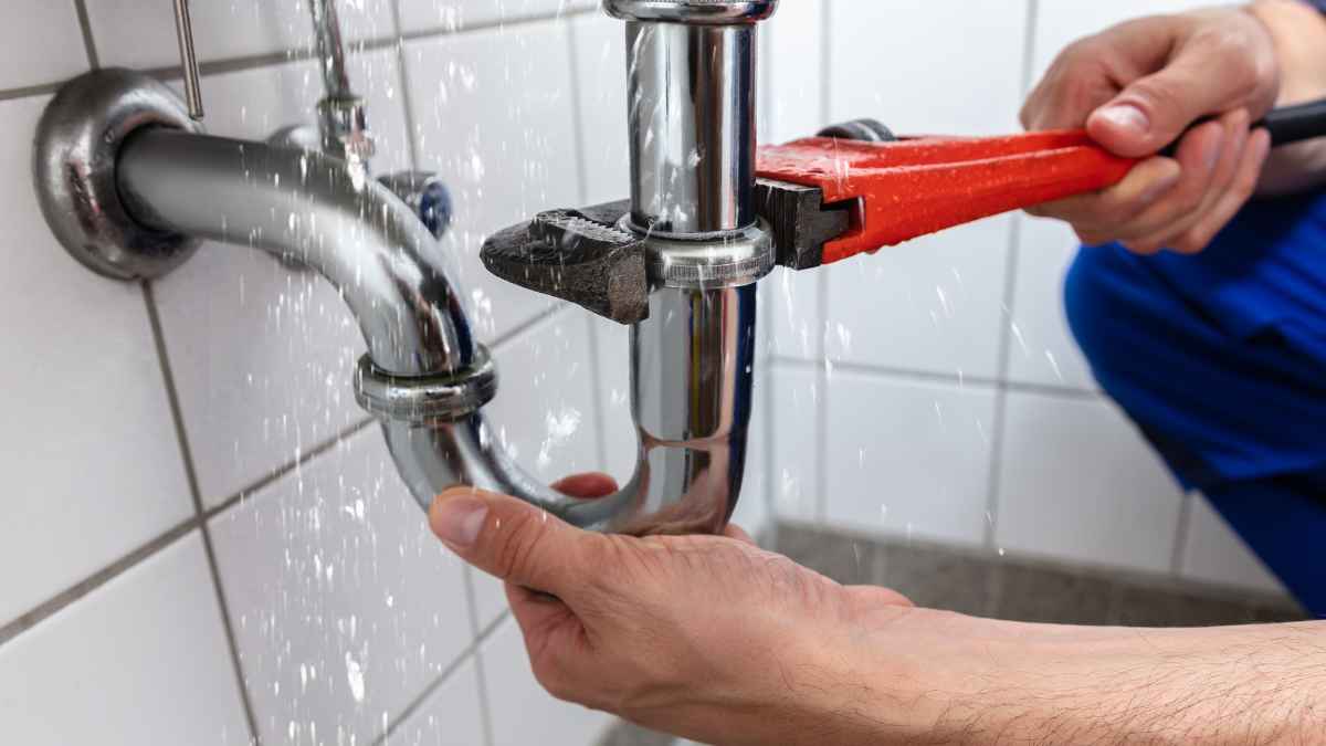 Fontanero autónomo de 75 años reparando una tubería para complementar su pensión baja