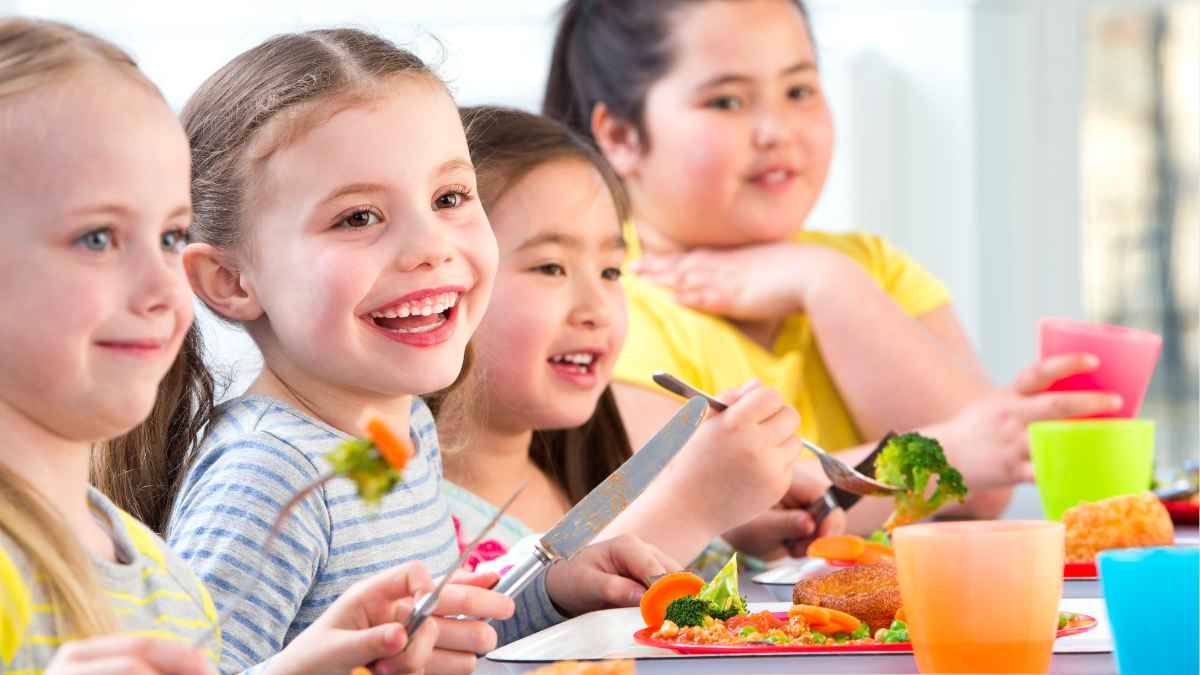 Niños de educación infantil comiendo en el comedor escolar en Santa Coloma durante el curso 2025-2026